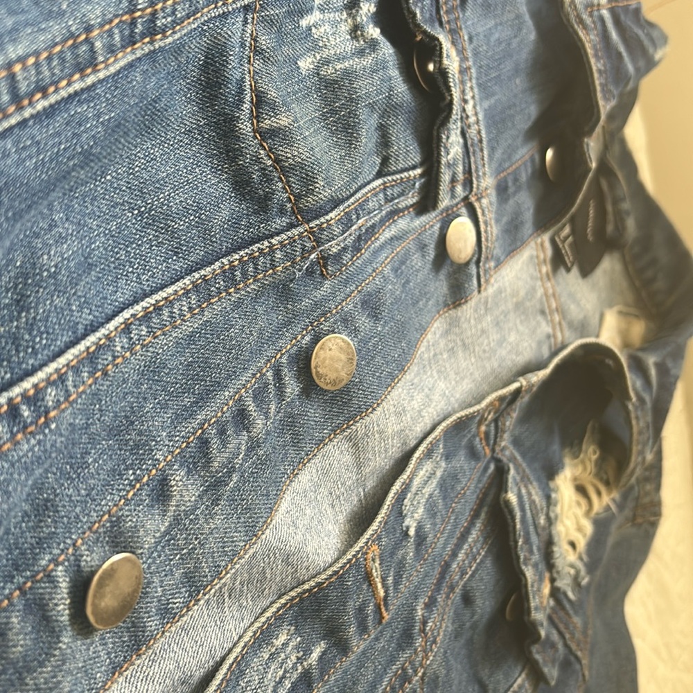 Ripped royal blue jean jacket , patched and stitched with pockets